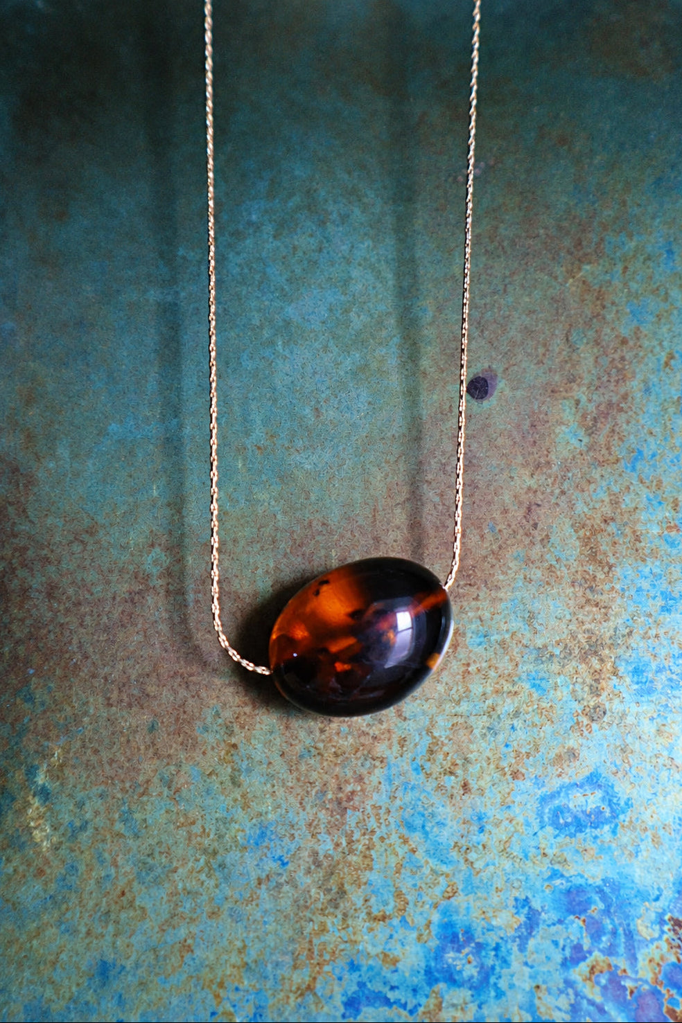 Deep cognac oval Baltic amber necklace on a fine gold chain