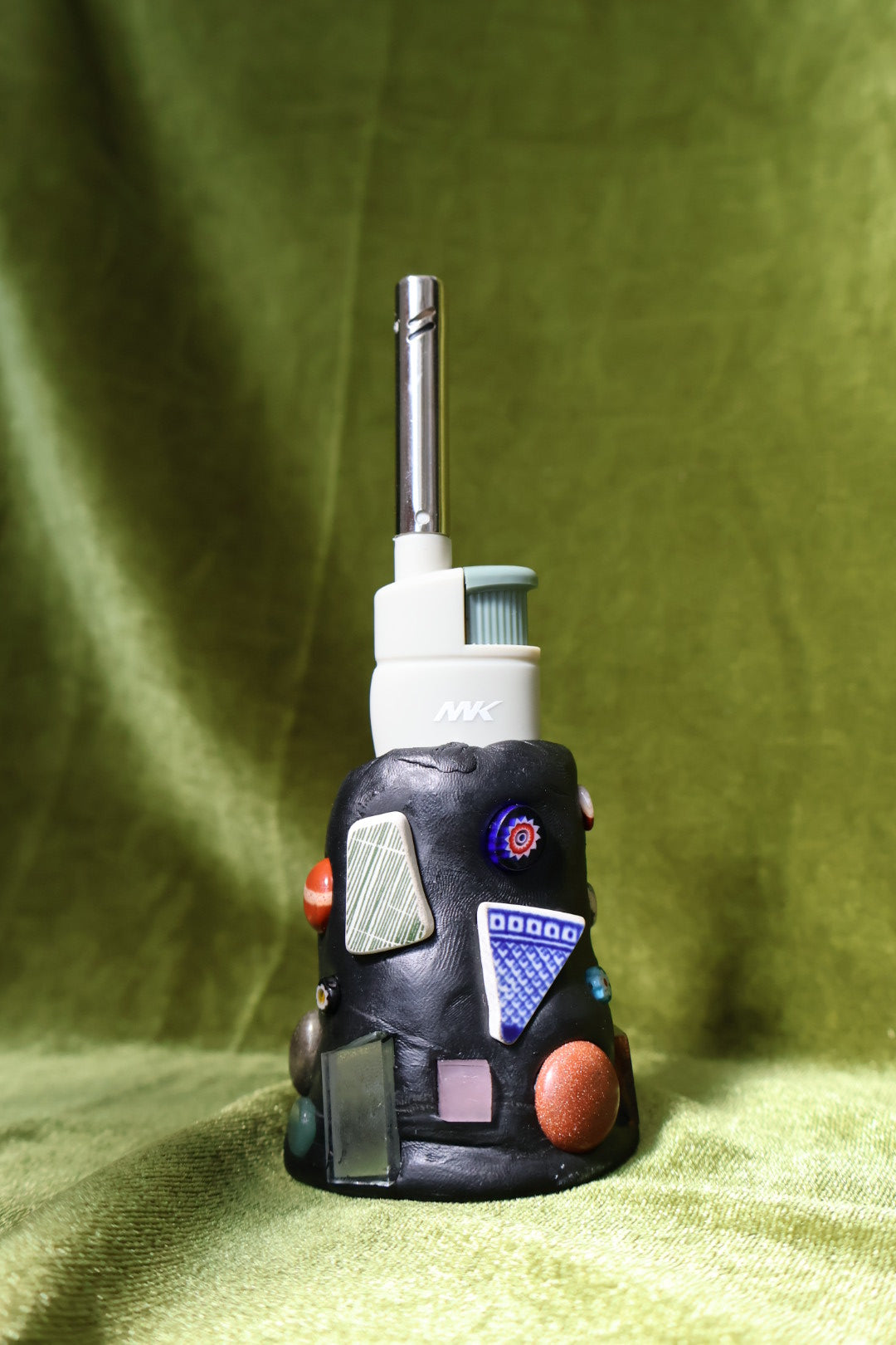 moss gem mosaic lighter holder on green velvet; lighter not included