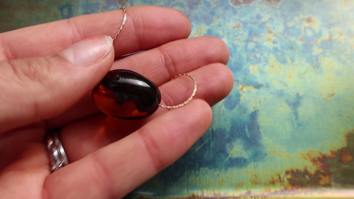 Cognac amber necklace, gold. Silent product video.
